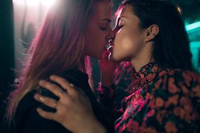 Close-Up Of Lesbian Couple Embracing Kissing Outdoors