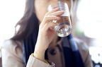 A woman drink a glass of water