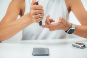 a woman conducting Blood Sugar Finger Prick Testing at Home for insulin resistance