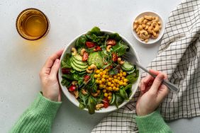 Person eating vegetarian salad