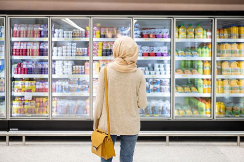 Woman buying yogurt at the grocery store
