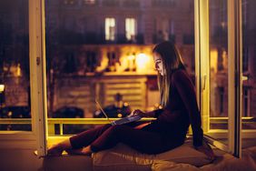 Woman using laptop staying up late night owl
