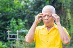Portrait Of An Elderly Man A Headache While Standing In Garden