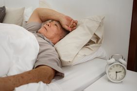 Asian senior man has an insomnia or sleepless on bed at home due to stress, nervous and concern