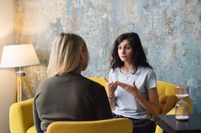 Woman psychologist talking to patient