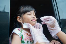 Little girl gets PCR COVID test through her nose. 