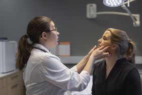 Doctor examining patient's face