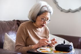 senior woman engaged in home healthcare screening and monitoring.