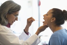 Herpes - doctor examining patient's mouth