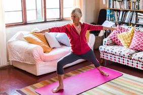 woman practicing yoga in living room