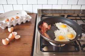 bacon and eggs cooking on stove
