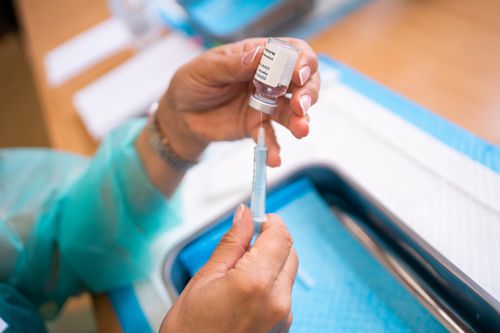 nurse hands preparing covid vaccine injections