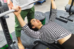woman lifting weights at gym