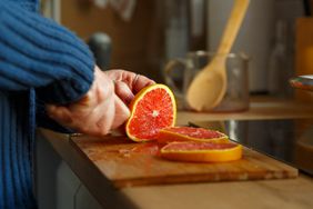 Woman cutting a grapefruit