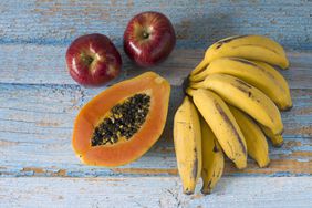 Close-up of apples, papaya and bunch of bananas; foods high in potassium