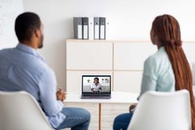 Black married couple having online session with psychologist, using laptop to communicate to marital counselor from home