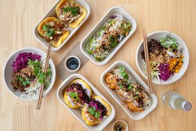 Asian fusion food in takeout boxes for online deliveries
