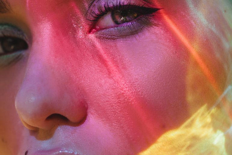 Colorful lights on woman face
