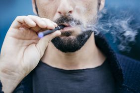 A man smoking an e-cigarette; vaping